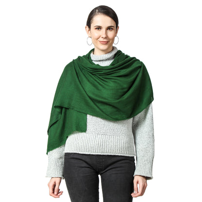 A woman wearing a Green Cashmere Scarf over a grey sweater and lack jeans